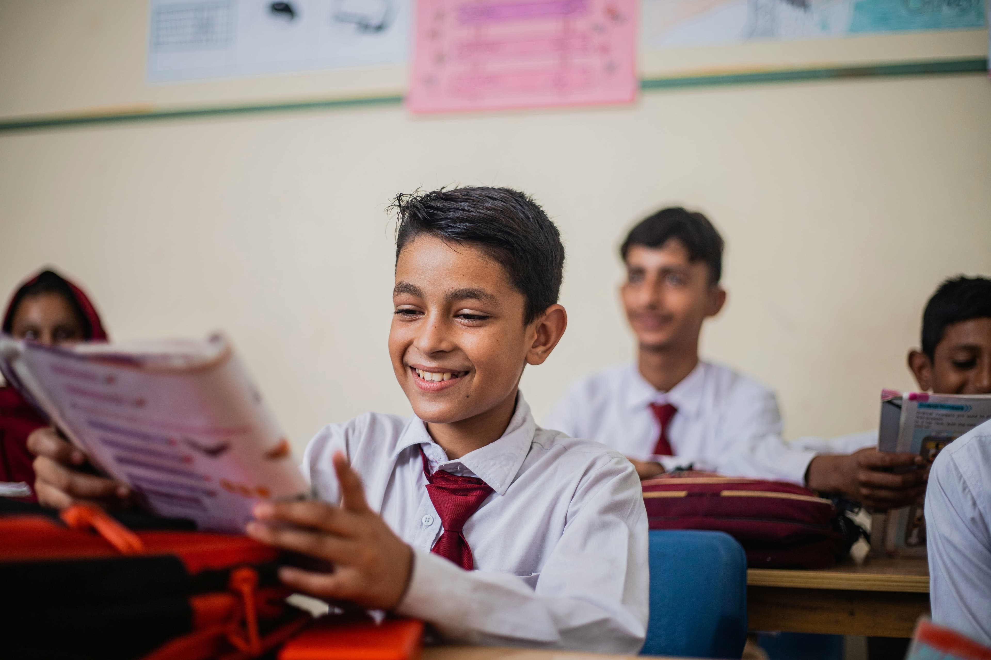 A teacher helping students one by one in class